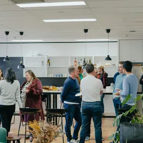 People talking at an office gathering