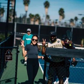 Two people on a pickleball court